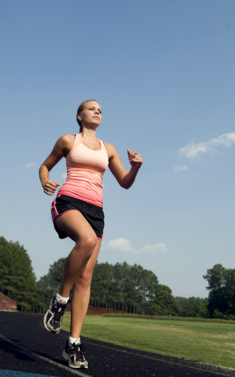 15322-a-healthy-young-woman-running-outdoors-on-a-track-pv
